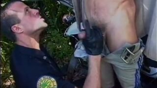 Two stud cops drop their pants and suck each other off - 2 image