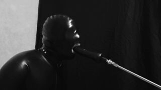 Rubber gimp train is throat with fuck machine