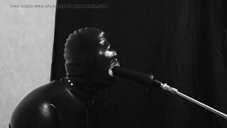 Rubber gimp train is throat with fuck machine