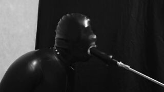 Rubber gimp train is throat with fuck machine