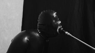 Rubber gimp train is throat with fuck machine