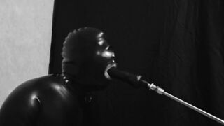 Rubber gimp train is throat with fuck machine