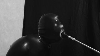 Rubber gimp train is throat with fuck machine