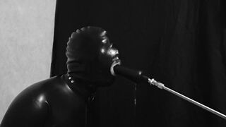 Rubber gimp train is throat with fuck machine