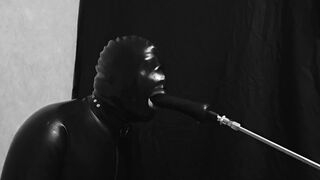 Rubber gimp train is throat with fuck machine