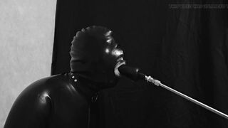 Rubber gimp train is throat with fuck machine